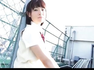 Cute Japanese schoolgirl in sleeveless cardigan