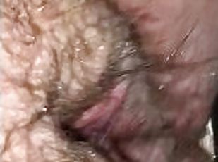 Slut rubs her wet hairy pussy in a public shower