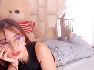 Redhead with glasses makes a living in erotic webcam shows