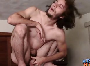 Skinny thug with long hair vigorously tugs on his hard cock